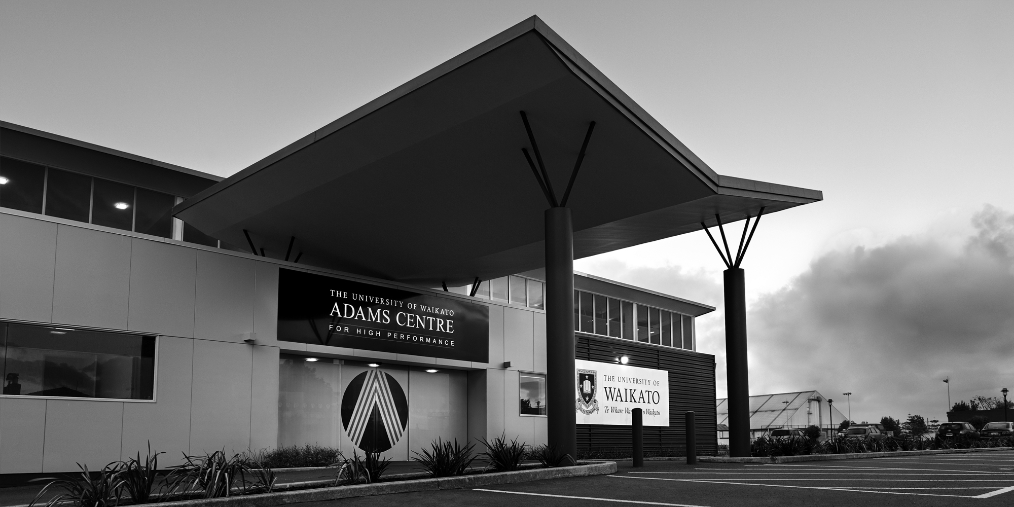 Outside front facade of the Adams Centre in black and white